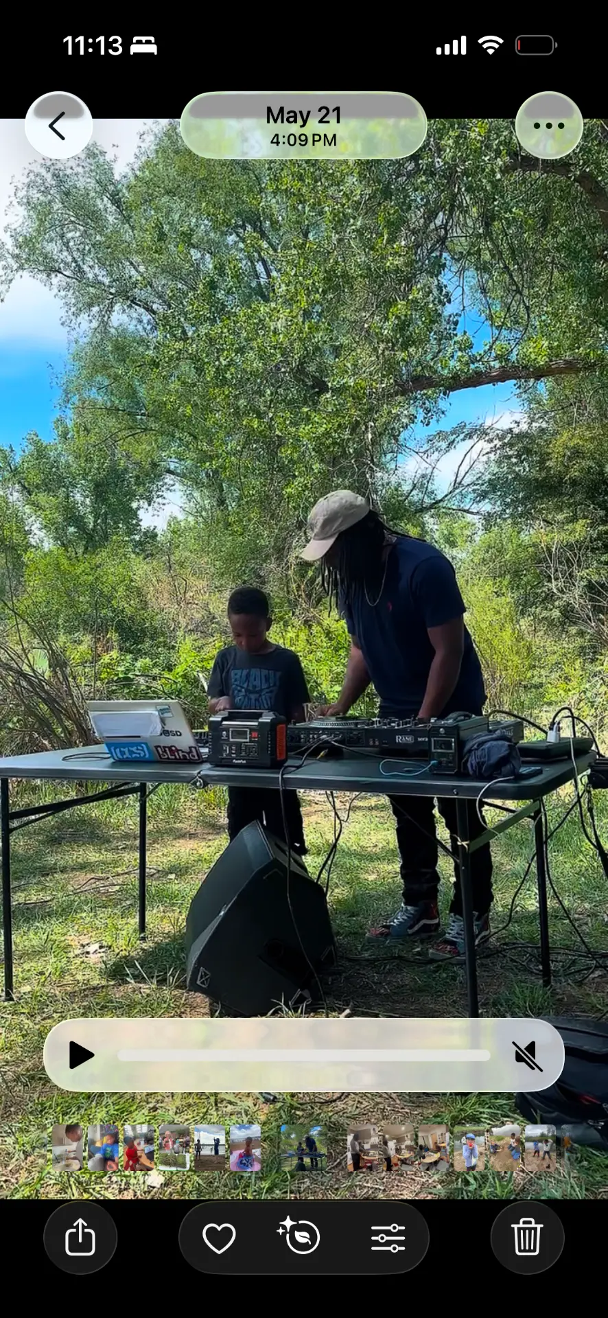 DJ King Kyro mixing outdoors alongside a mentor DJ
